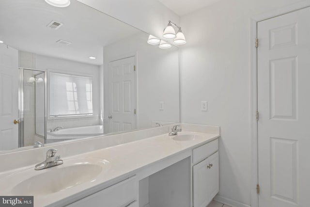 full bath featuring double vanity, a shower stall, visible vents, and a sink