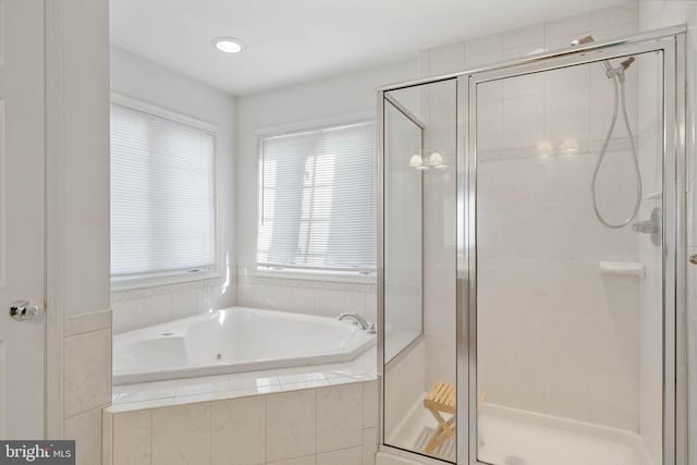 full bathroom featuring a shower stall and a bath