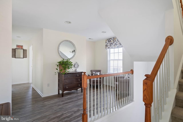 corridor with recessed lighting, wood finished floors, and baseboards