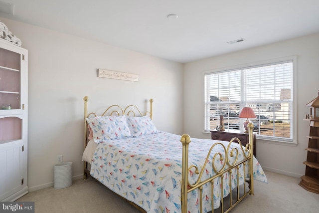 carpeted bedroom with baseboards and visible vents