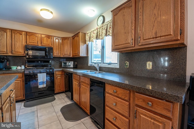 kitchen featuring sink, light tile patterned floors, decorative backsplash, and black appliances