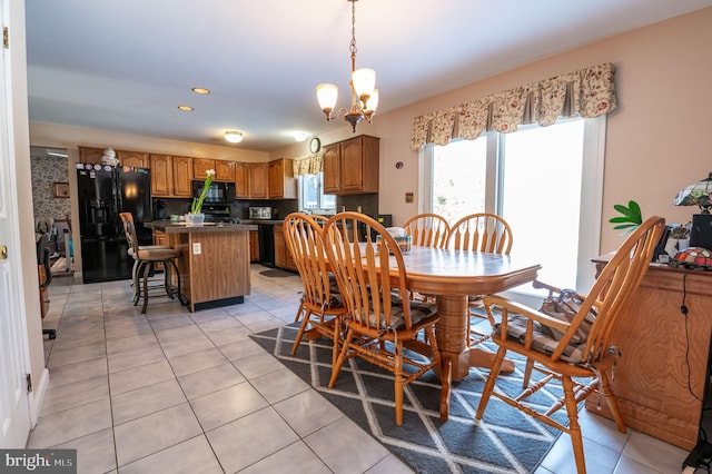 dining area featuring an inviting chandelier and light tile patterned floors