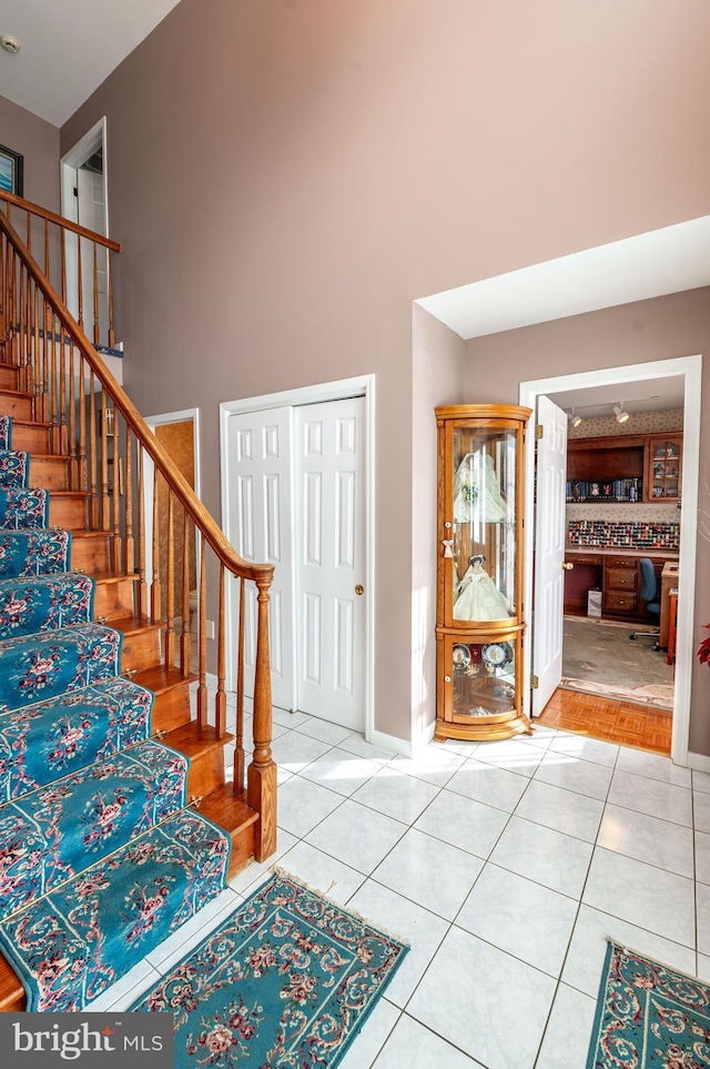 tiled foyer featuring a high ceiling