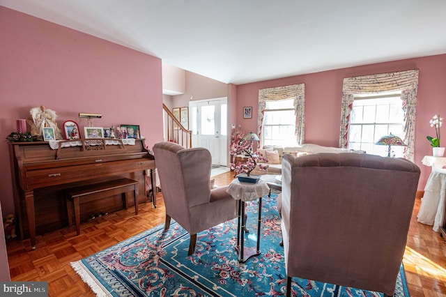 living room featuring lofted ceiling and parquet floors