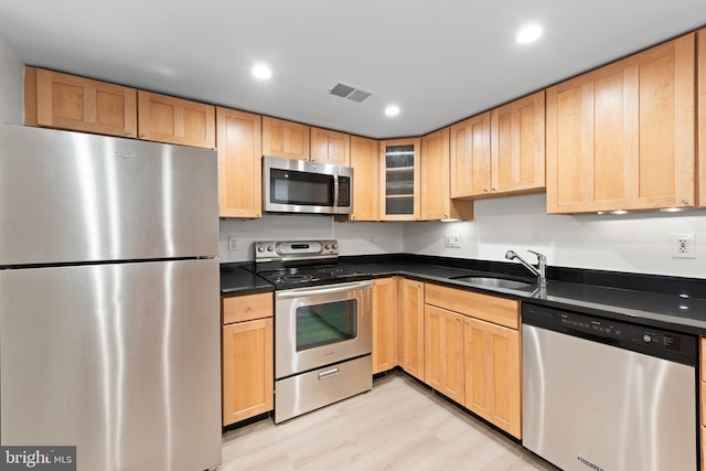 kitchen with light brown cabinetry, sink, and appliances with stainless steel finishes