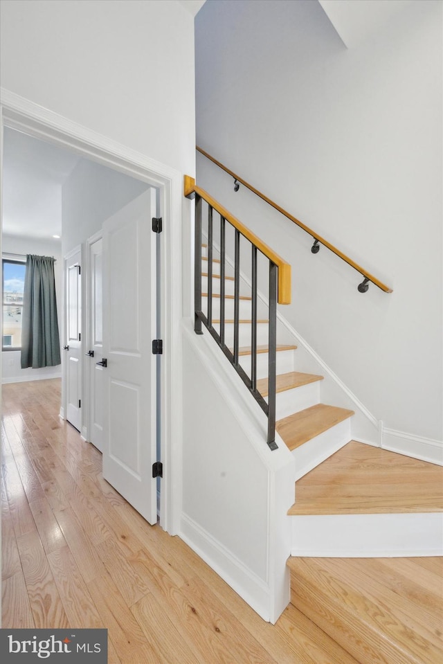 staircase with hardwood / wood-style floors