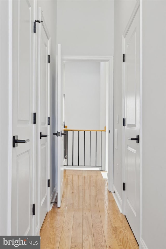 hall with light hardwood / wood-style flooring