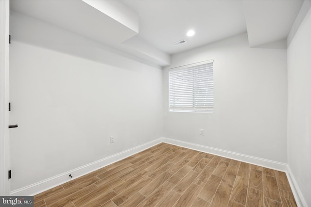 spare room featuring wood-type flooring