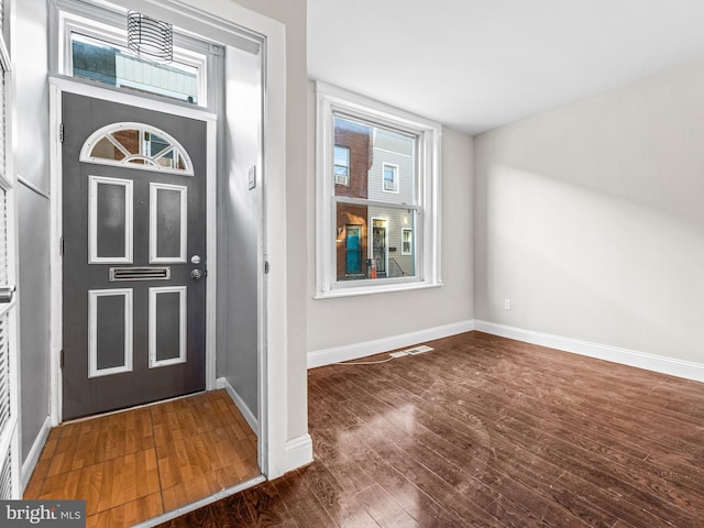 foyer with dark hardwood / wood-style flooring