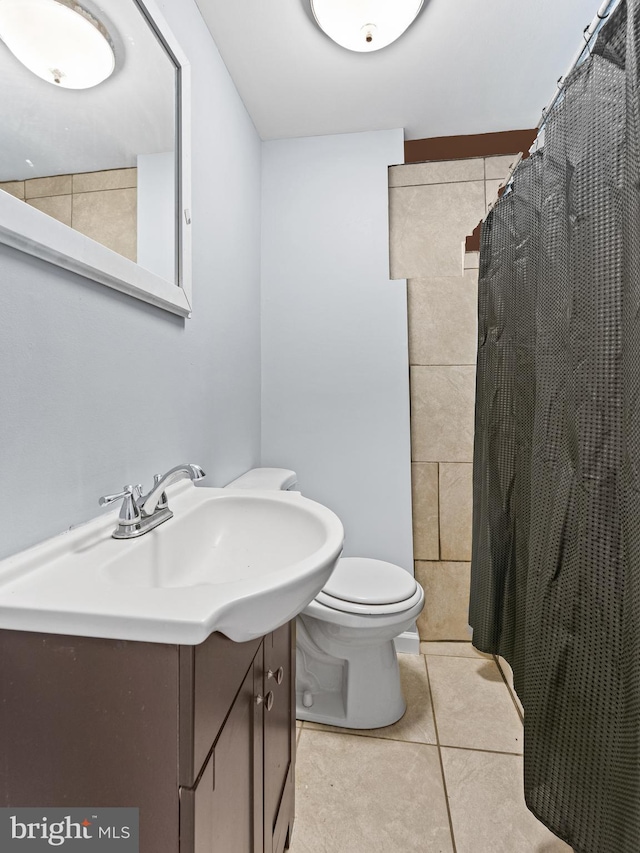 bathroom with vanity, tile patterned flooring, a shower with curtain, and toilet