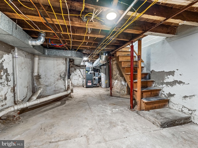 basement featuring gas water heater and heating unit