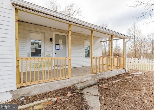 view of exterior entry with a porch