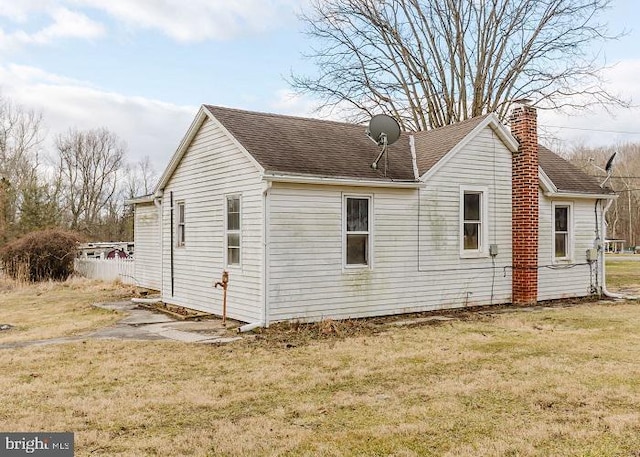 view of property exterior with a lawn