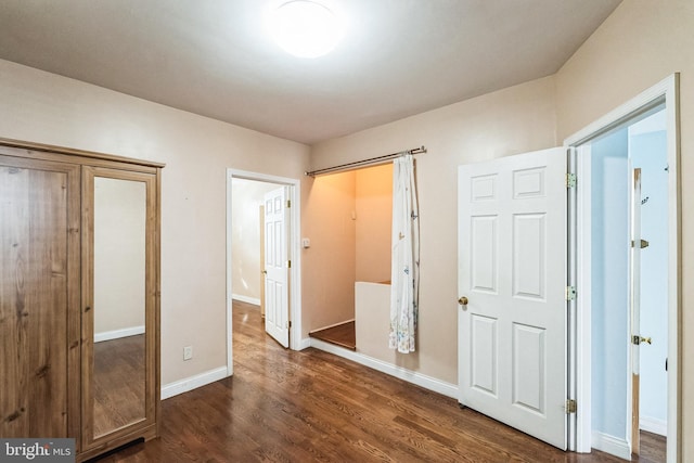 unfurnished bedroom featuring dark hardwood / wood-style flooring