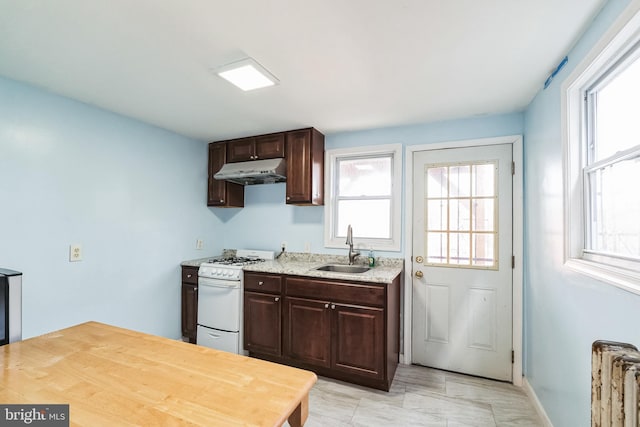 kitchen with a wealth of natural light, sink, radiator heating unit, and gas range gas stove