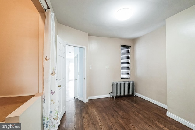 interior space featuring dark wood-type flooring and radiator heating unit