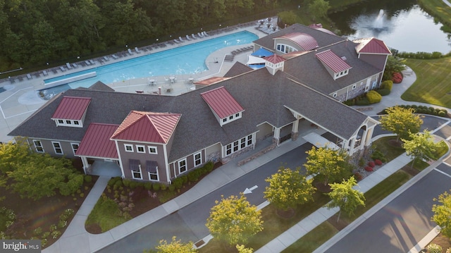 birds eye view of property with a water view