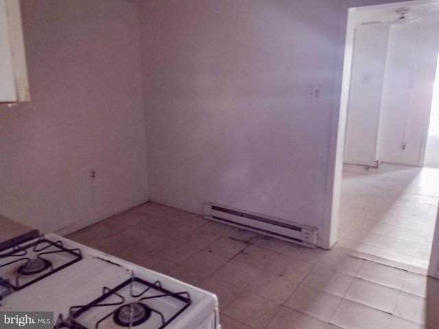 kitchen with a baseboard heating unit, white range with gas cooktop, and light tile patterned floors