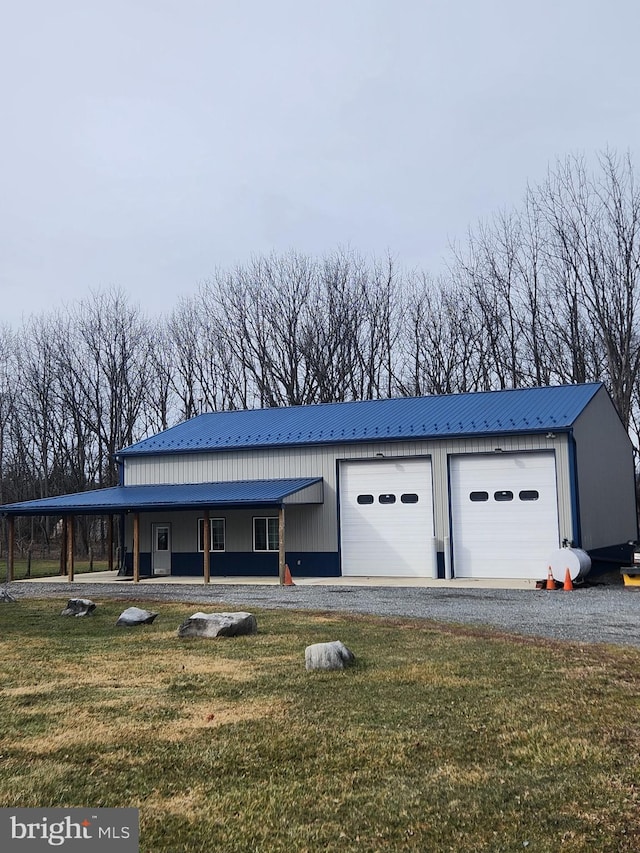 exterior space featuring a carport, a garage, covered porch, and a front lawn