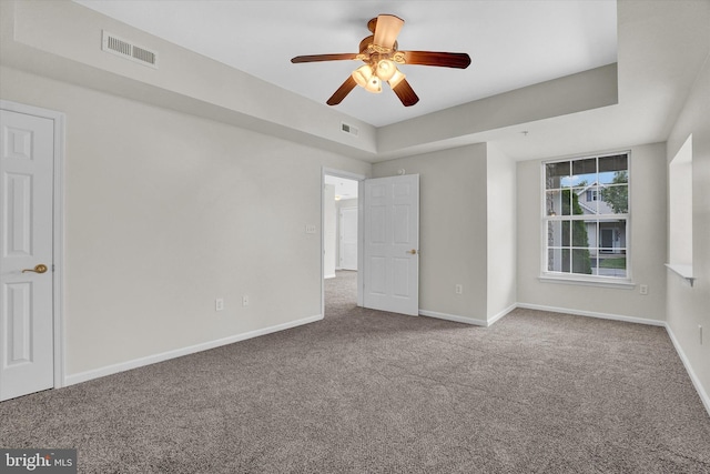 carpeted spare room featuring ceiling fan