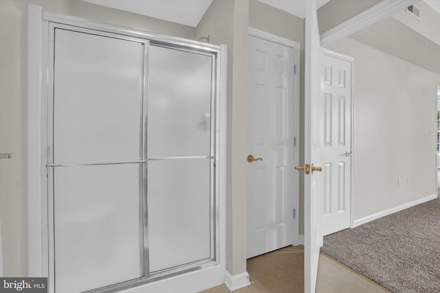 bathroom featuring a shower with shower door