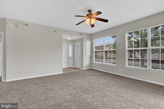 carpeted spare room with ceiling fan