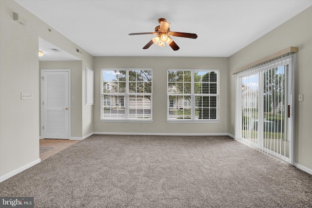 carpeted spare room with ceiling fan