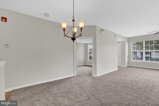 interior space with an inviting chandelier and carpet flooring