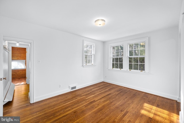 empty room featuring hardwood / wood-style floors and a healthy amount of sunlight