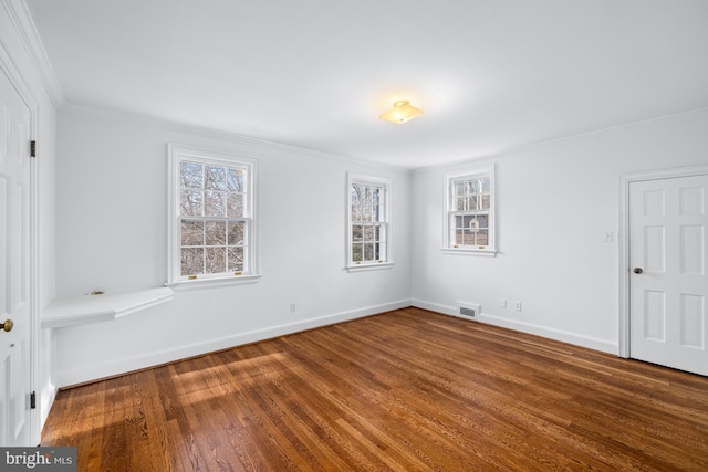 unfurnished room featuring wood-type flooring and ornamental molding