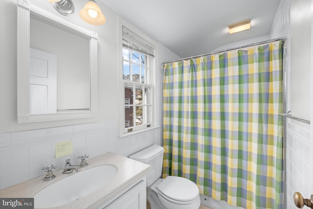 bathroom featuring tile walls, vanity, a shower with curtain, and toilet