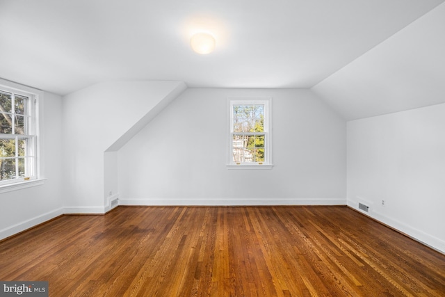 bonus room with lofted ceiling and hardwood / wood-style floors