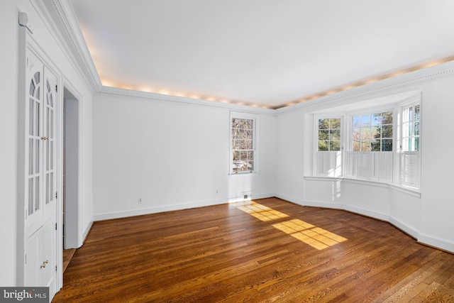 spare room featuring crown molding and hardwood / wood-style floors