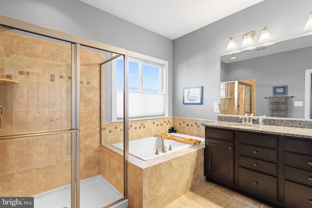 bathroom with vanity, plus walk in shower, and tile patterned flooring