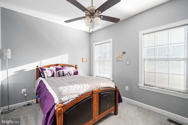 bedroom featuring light colored carpet and ceiling fan