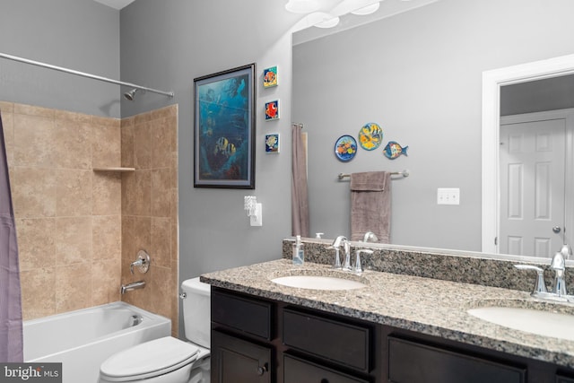 full bathroom with vanity, shower / bath combo with shower curtain, and toilet