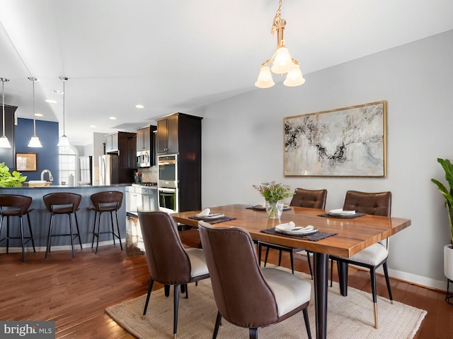 dining area with dark hardwood / wood-style flooring