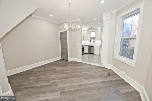 unfurnished dining area with baseboards, ornamental molding, wood finished floors, and recessed lighting