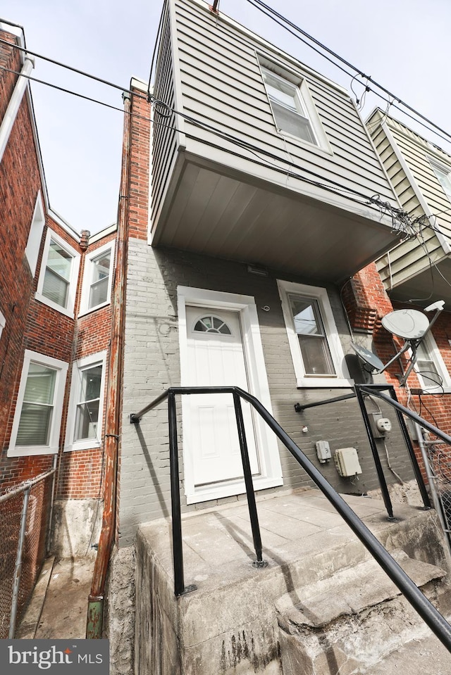 property entrance featuring brick siding