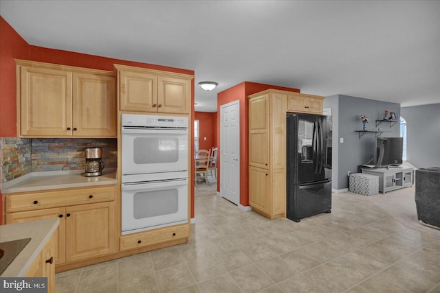 kitchen featuring decorative backsplash, light brown cabinetry, and black appliances