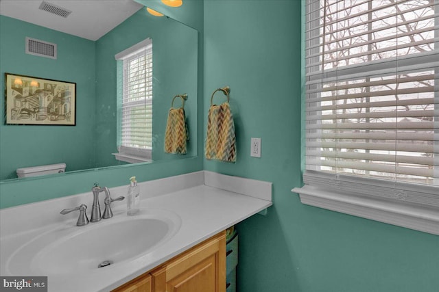 bathroom with vanity and toilet