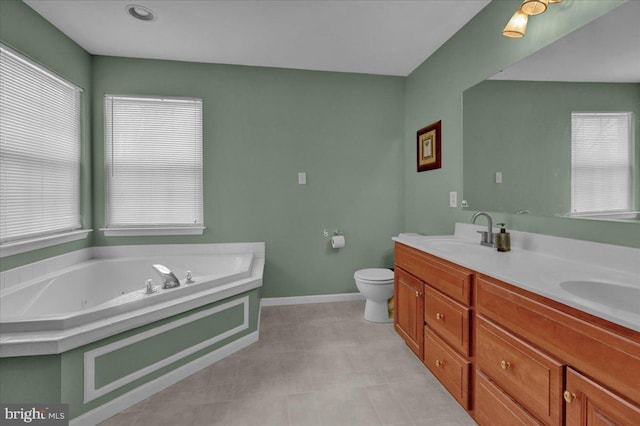 bathroom featuring vanity, plenty of natural light, a tub, and toilet