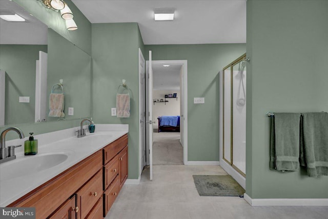 bathroom featuring vanity and a shower with door