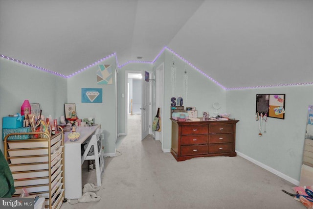 bedroom with vaulted ceiling and light carpet