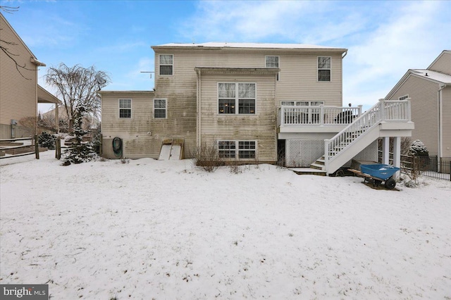 snow covered property featuring a wooden deck