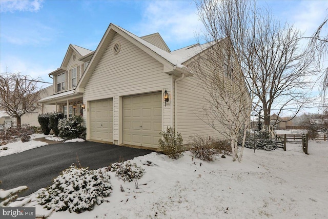 view of snowy exterior with a garage