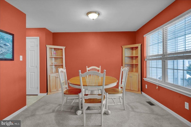 dining space with light carpet