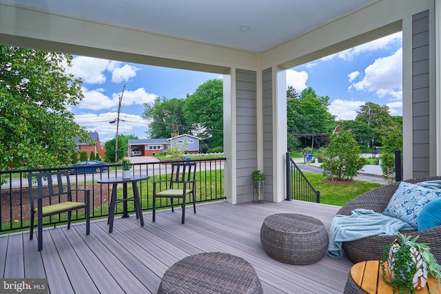 wooden terrace featuring a lawn