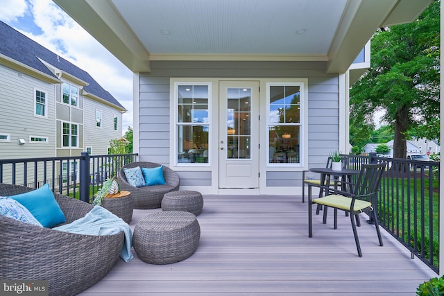 wooden terrace with an outdoor living space