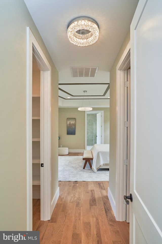 corridor with light hardwood / wood-style flooring